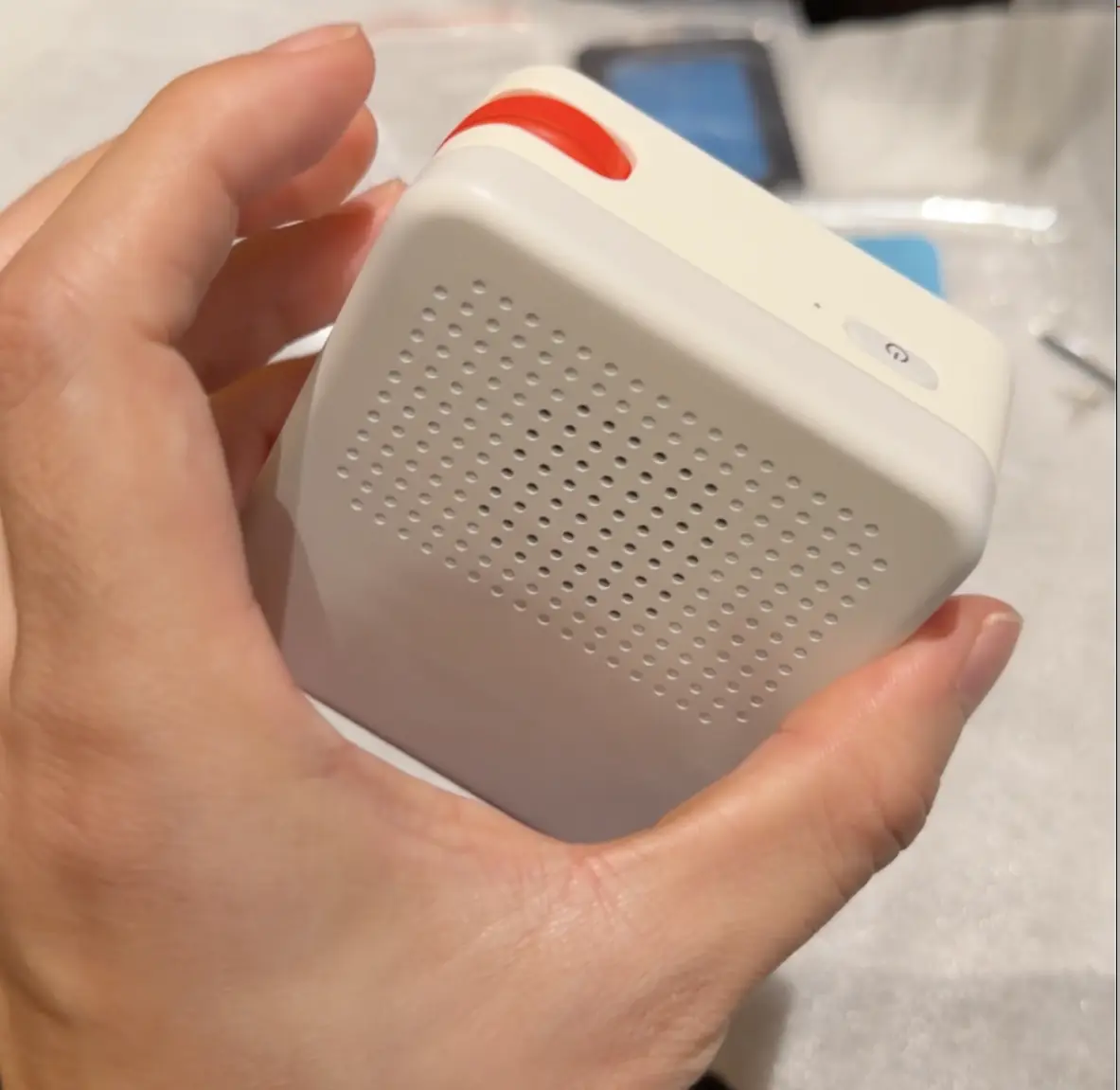 The back of a Nowa prototype: speaker grille, power button, and red scroll wheel